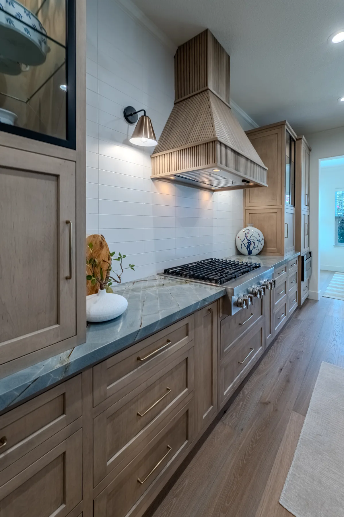 Custom range wall with integrated cabinetry and drawer storage