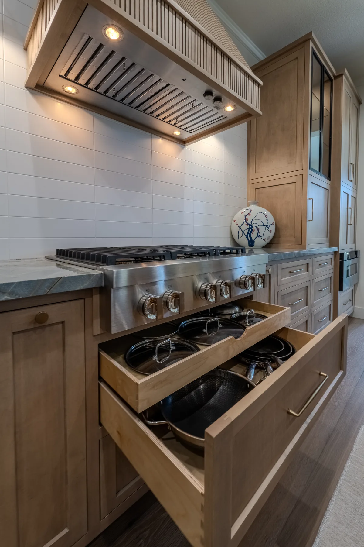 Custom pull-out cabinet storage built beside a kitchen range