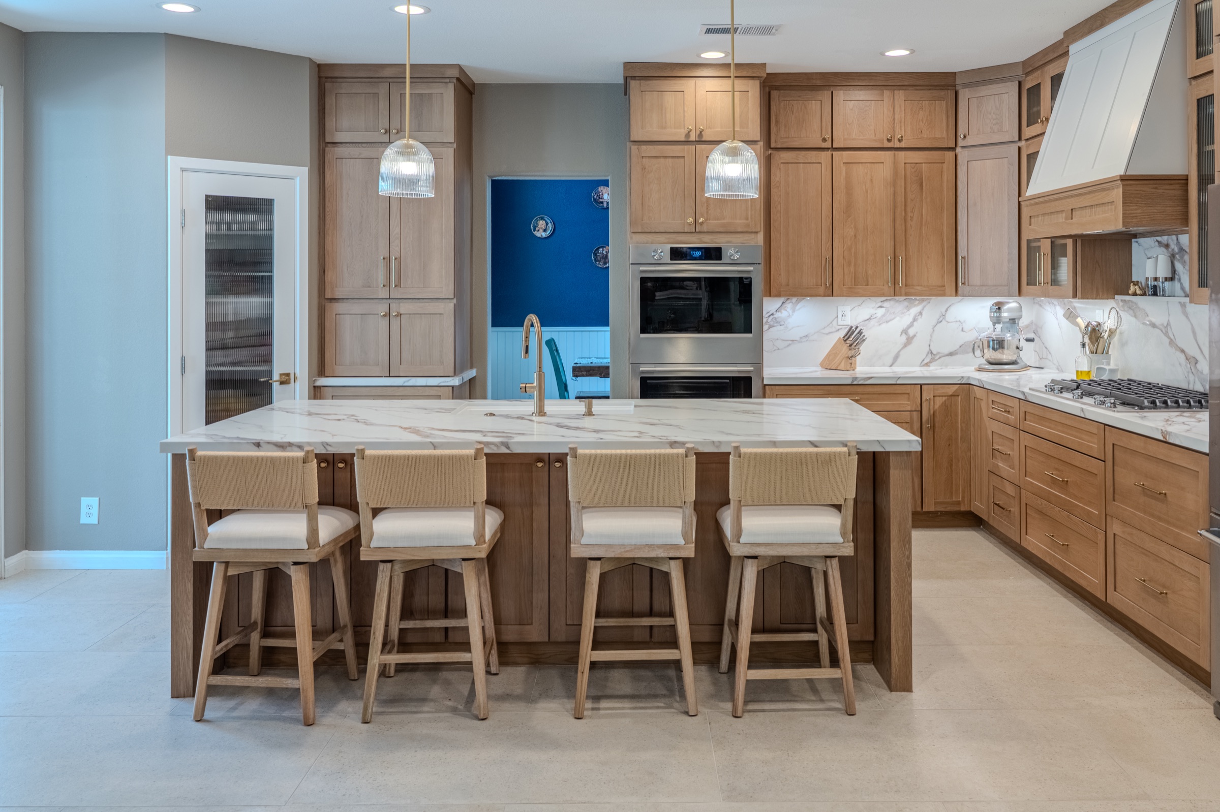 Oak cabinetry and full-height stone