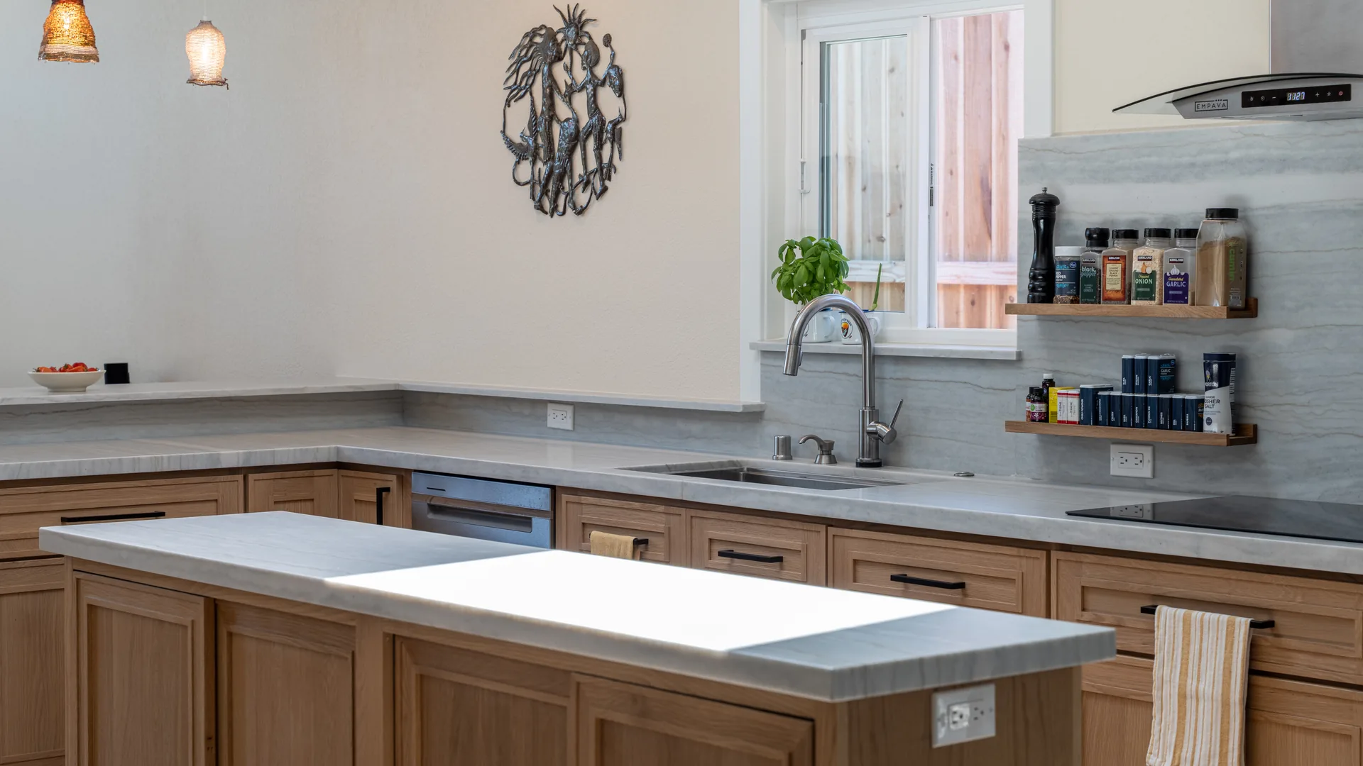 Finished Pacific Stone kitchen with stone countertops and a full-height backsplash