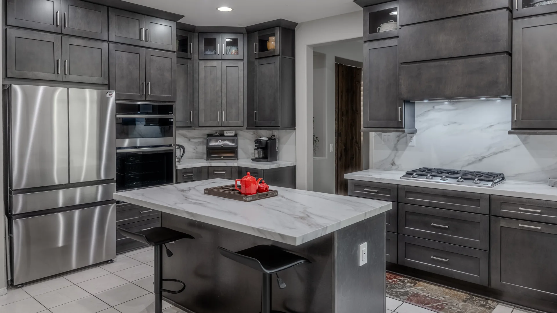 Finished Pacific Stone kitchen with custom cabinetry and integrated storage