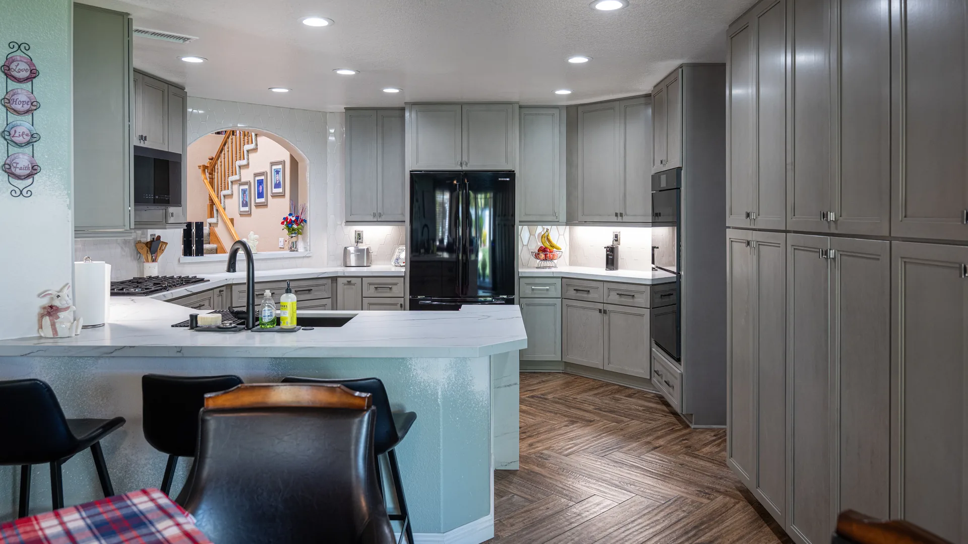Finished Pacific Stone kitchen with stone countertops and a full-height backsplash