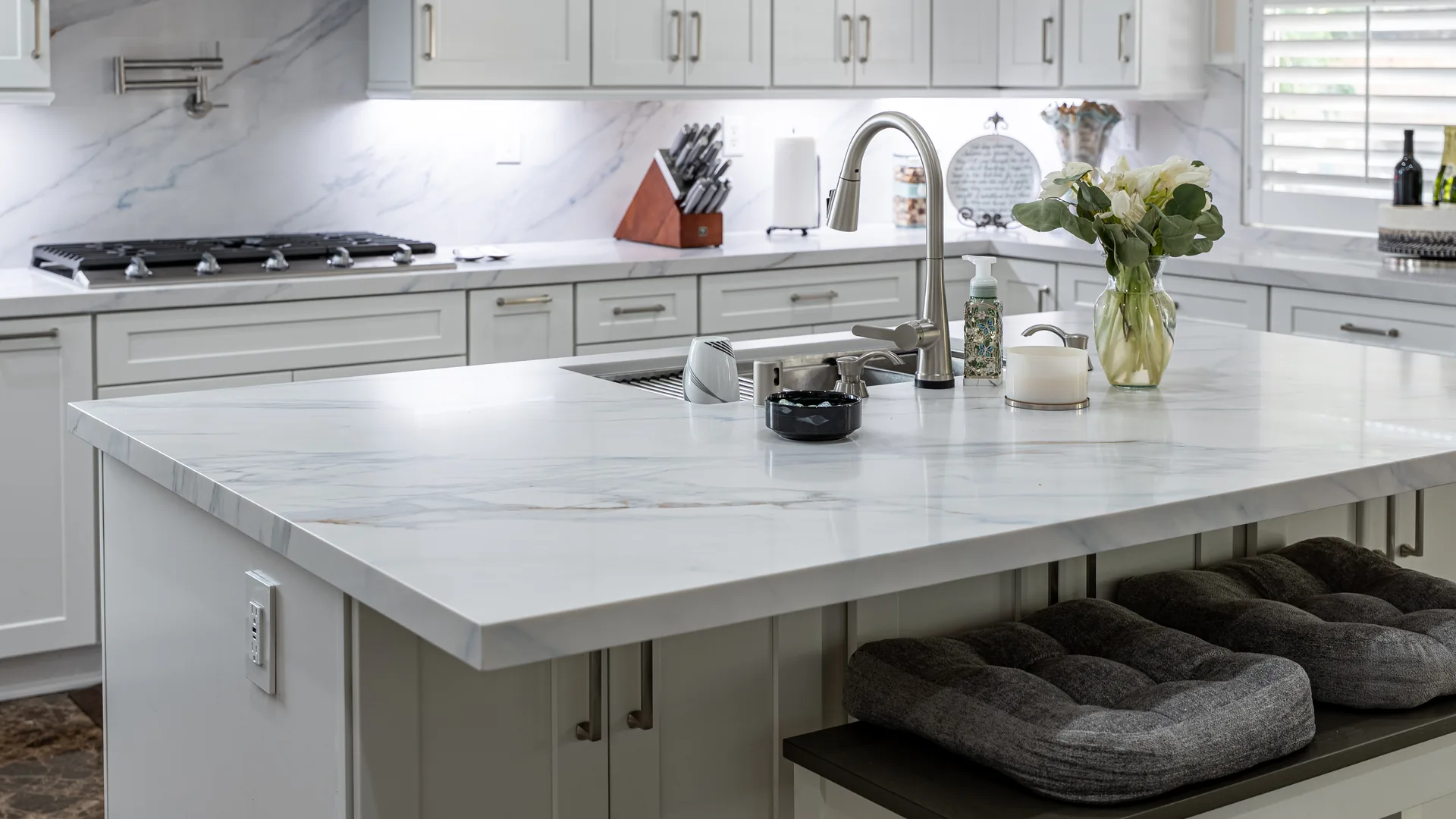 Finished Pacific Stone kitchen with stone countertops and a full-height backsplash