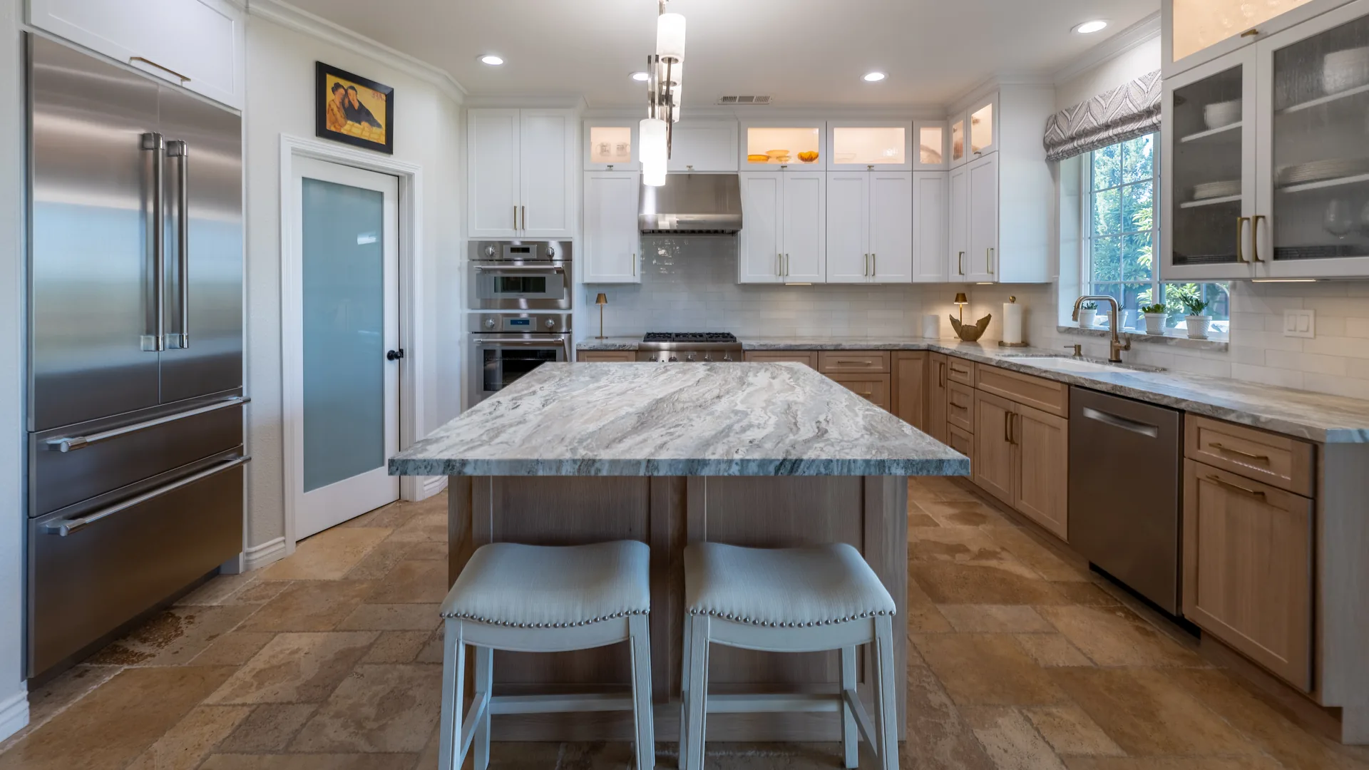 Finished Pacific Stone kitchen with stone countertops and a full-height backsplash