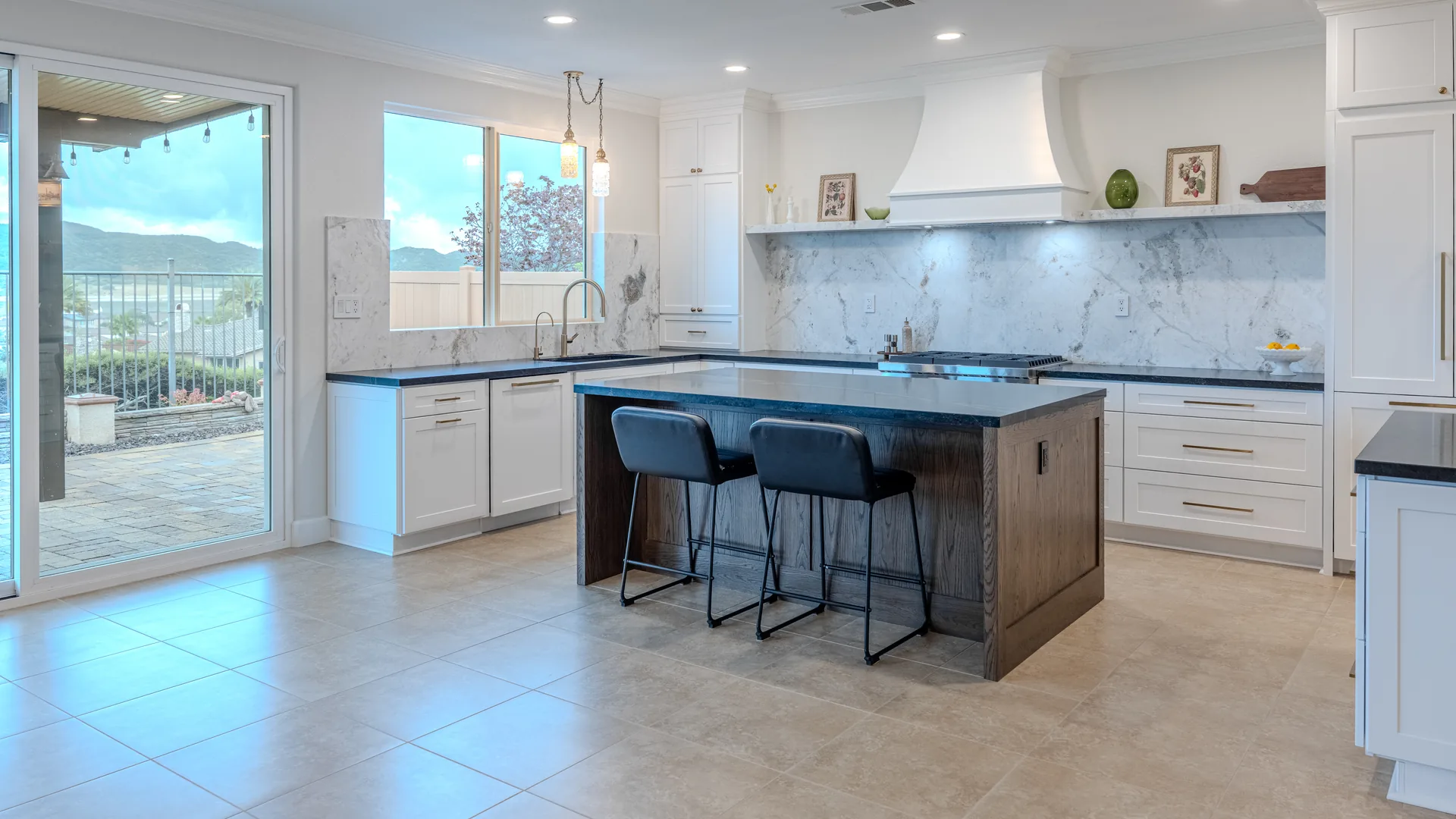 Finished Pacific Stone kitchen with stone countertops and a full-height backsplash