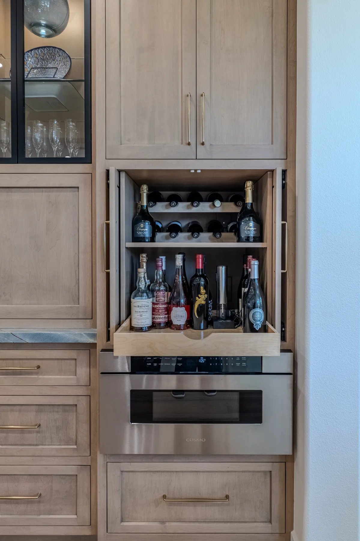Custom beverage cabinet with wine storage, drawers, and integrated appliances