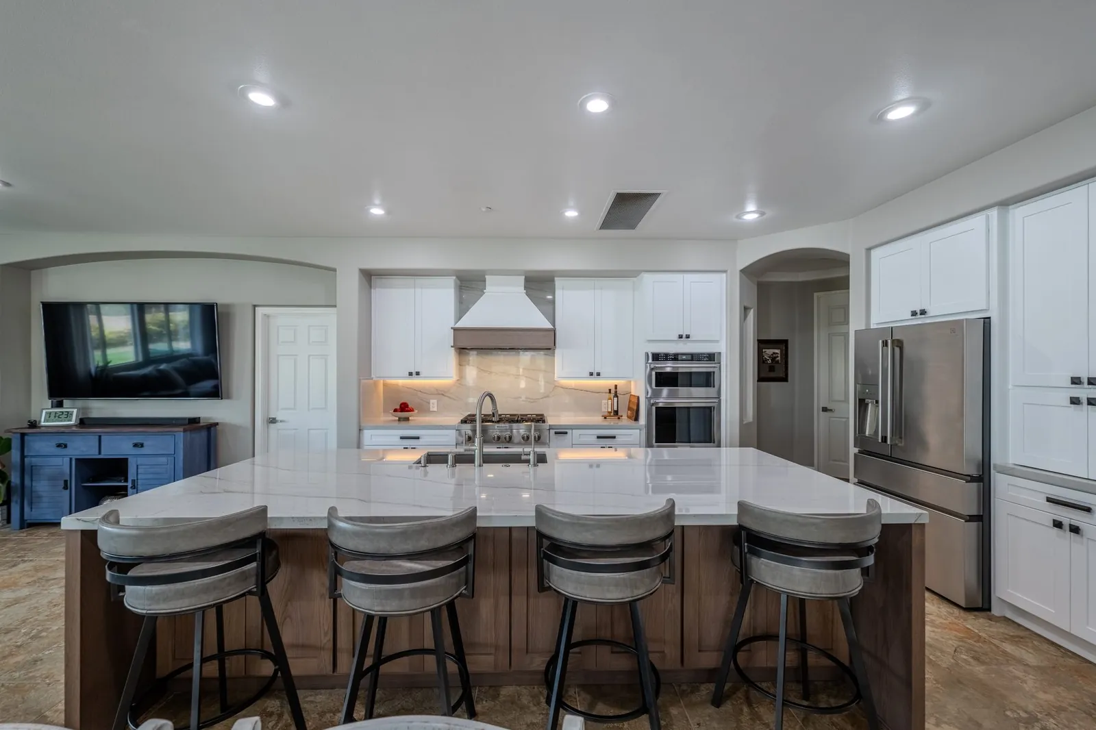 White quartz countertops and island with full-height backsplash