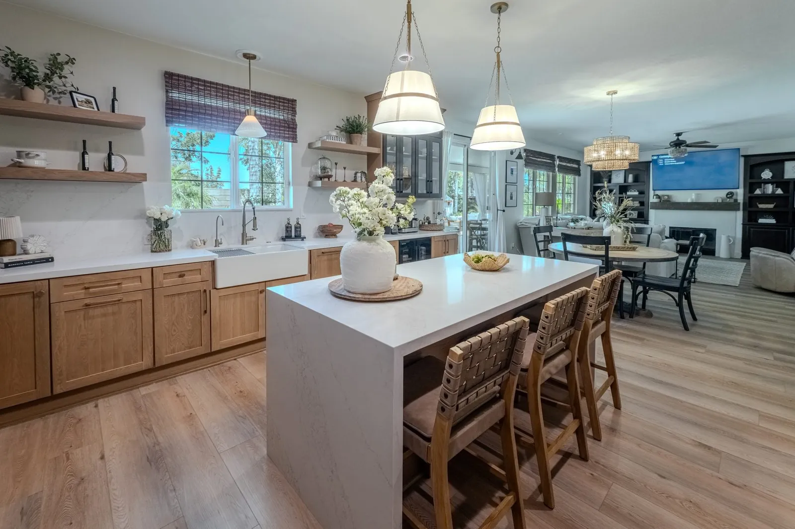 Oak kitchen cabinets with waterfall island and open shelving