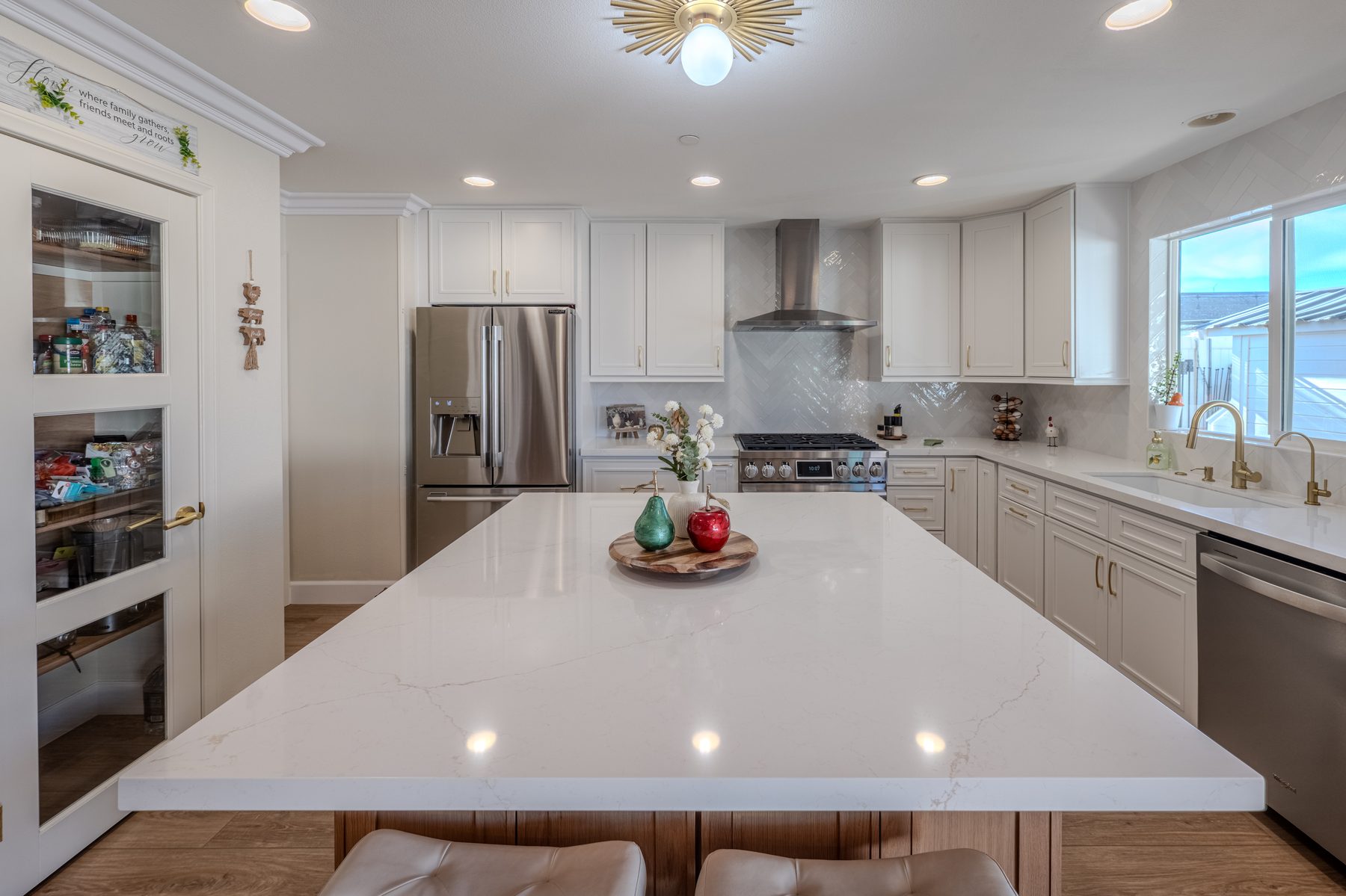 White countertops with mixed oak and white kitchen cabinetry