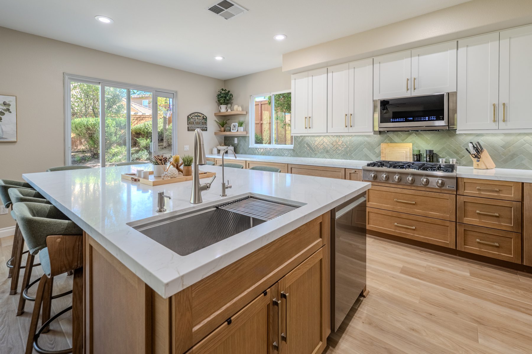 White and oak kitchen with large island and built-in sink