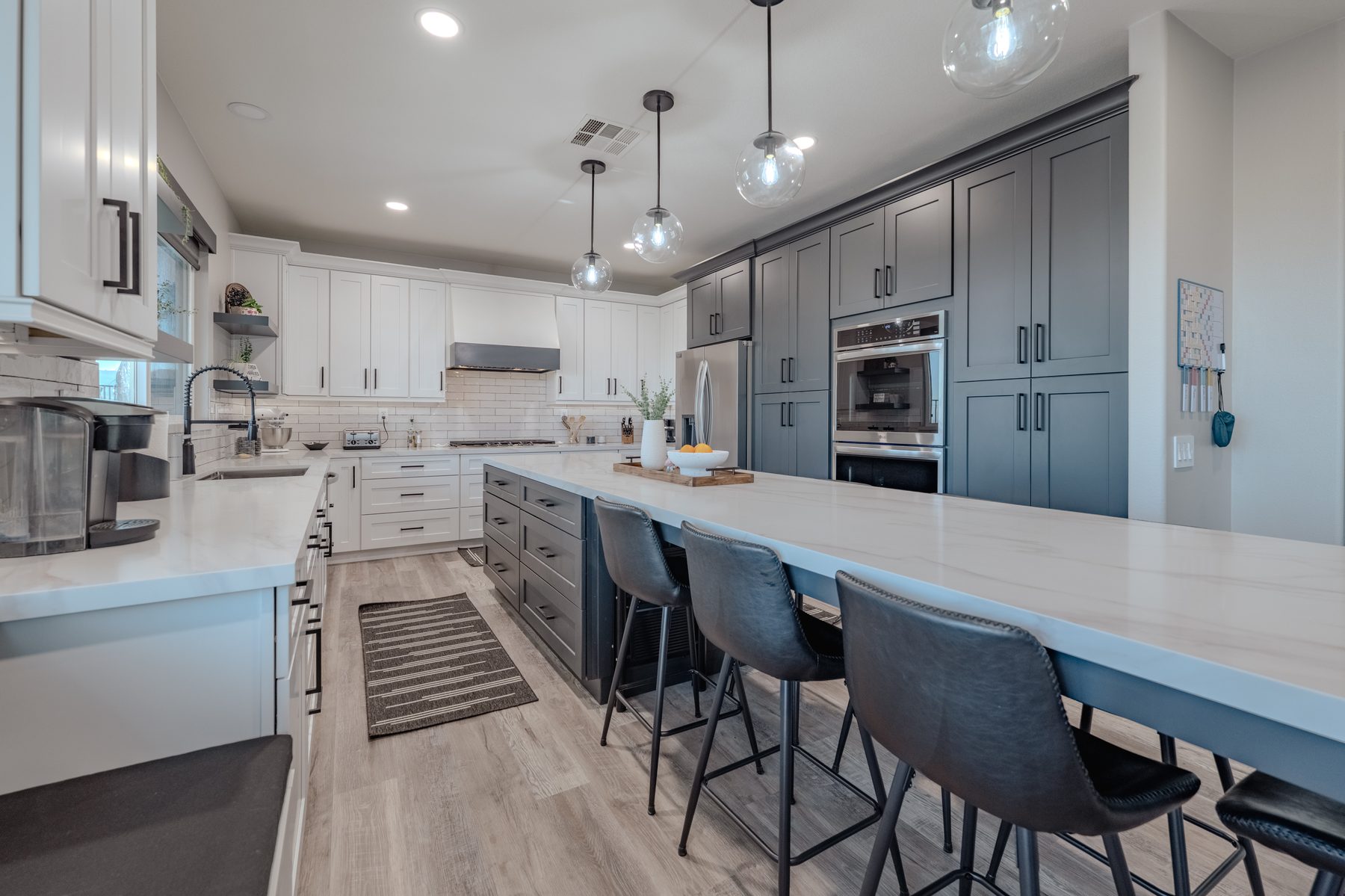 Two-tone gray and white kitchen with long island seating